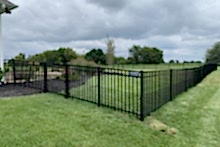 Ornamental Montage Majestic steel fence with 2' tall black vinyl chain link puppy border